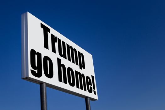 Big ad panel, embossed with the message "Trump go home!", against blue sky.
