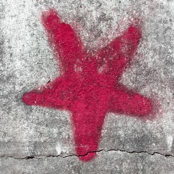 Red star painted on grungy wall