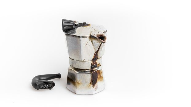 Vintage Moka pot forgotten on the fire. Burned with in molten plastic components.