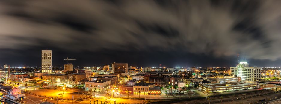 Beautiful panoramic aerial view of down town in Galveston, Texas. Long exposure. Night cloudy sky in the background.