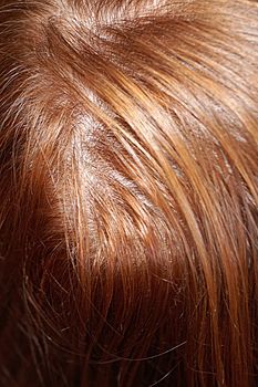 female head with red hair, top view.