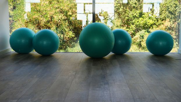 fitness balls by the window in the gym close up