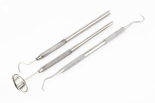 Dental mirror scaler and sickle probe explorer tools on a white background
