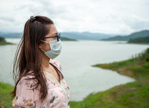 Portrait of a woman wearing a protective mask On the background as a tourist attraction.