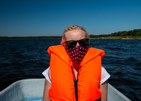 Woman in the lake with life jackets and face mask, Covid-19, coronavirus, water