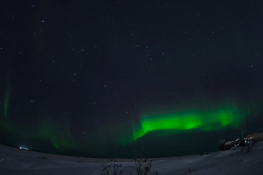 Northern Lights in the night sky. Northern Lights in the tundra.