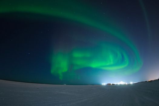 Northern Lights in the night sky. Northern Lights in the tundra.