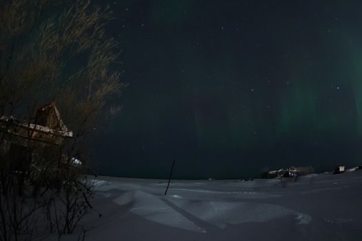 Northern Lights in the night sky. Northern Lights in the tundra.