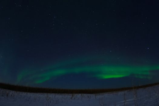 Northern Lights in the night sky. Northern Lights in the tundra.