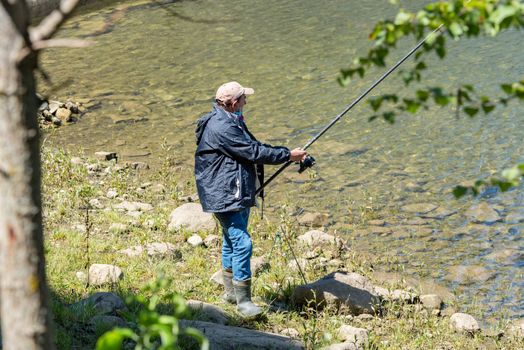 Escaldes Engodany, Andorra : 20 August 2020 : Fisherman in the Engolasters lake  in Escaldes Engordany, Andorra in summer 2020