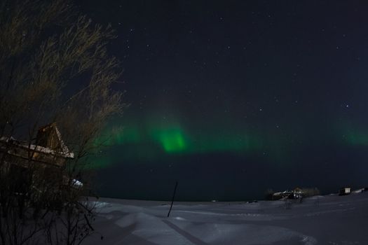 Northern Lights in the night sky. Northern Lights in the tundra.