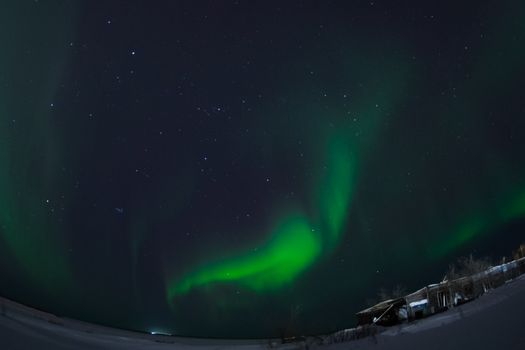 Northern Lights in the night sky. Northern Lights in the tundra.