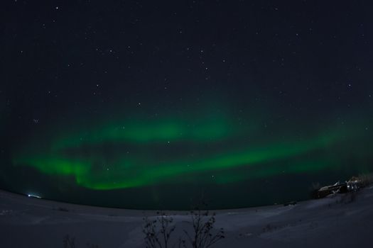 Northern Lights in the night sky. Northern Lights in the tundra.