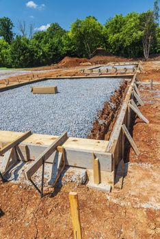 Vertical shot of wooden framework for a concrete slab to be poured for new commercial construction.