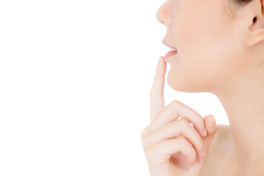 Beauty asian young woman with clean fresh skin touch lips. Cosmetology, cosmetic beauty and spa concept. Model hold a finger to mouth.
