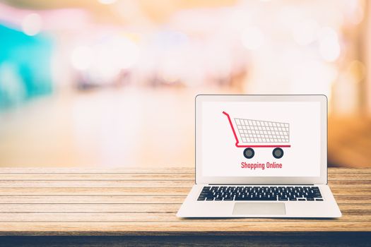 shopping online with labtop, notebook on table top and bokeh background, shop with computer.