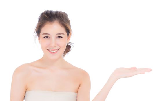 Asian beautiful young woman showing with healthy clean skin presenting something empty copy space on the hand isolated on white background, beauty concept.