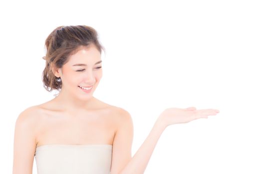 Asian beautiful young woman showing with healthy clean skin presenting something empty copy space on the hand isolated on white background, beauty concept.