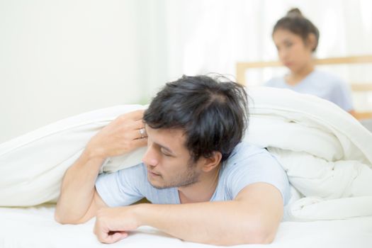 Relationship difficulties, conflict and family concept - unhappy couple having problems at bed - lover with conflict and stress on bedroom.