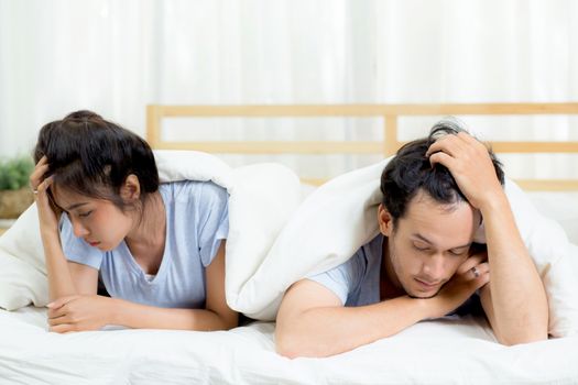 Relationship difficulties, conflict and family concept - unhappy couple having problems at bed - lover with conflict and stress on bedroom.