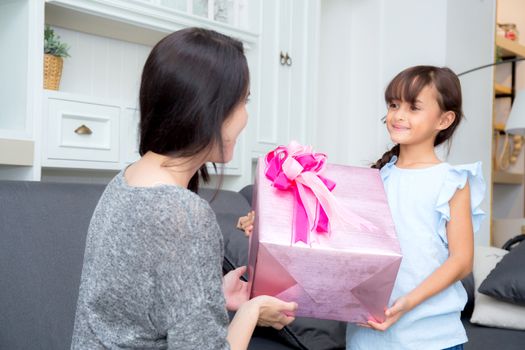 happy of mother and daughter asian with gift with pink ribbon and daughter kissing mother, Happy family concept. Happy mother's day.