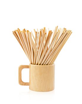 Wheat Straws for drinking water natural eco friendly renewable in wooden water glass on white background.