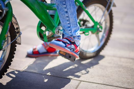 Bicycle pedal close up. The child is pedaling. Healthy lifestyle concept