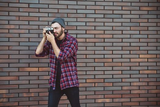 Say cheese, hipster fashion photographer man holding retro camera