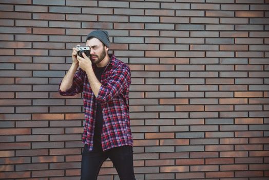 Say cheese, hipster fashion photographer man holding retro camera