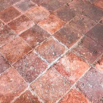 Rustic floor with old tiles inside an Italian country house