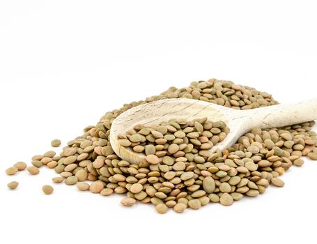 Heap of green lentil isolated on white background with wooden spoon