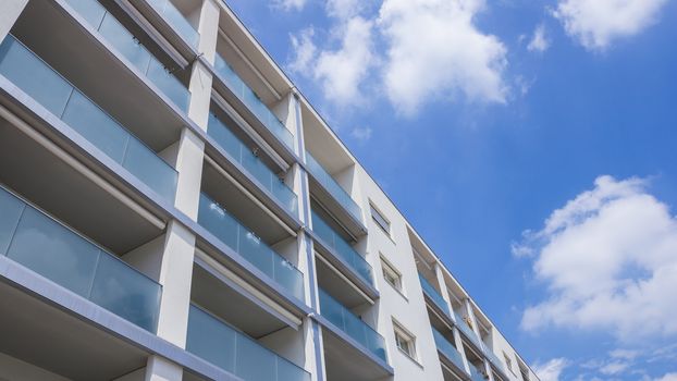 Modern apartment buildingn on a sunny day with a blue sky. Facade of a new apartment building.