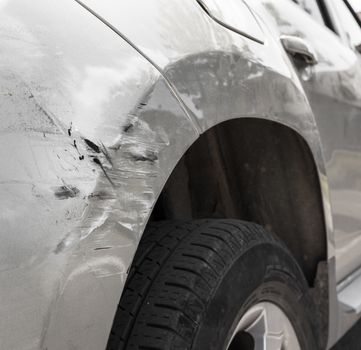 Dents on the car caused by the accident. Close-up.