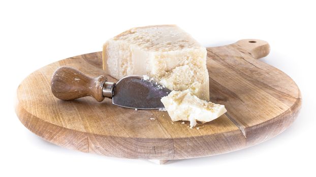 Wooden cutting board with flaked Parmesan.