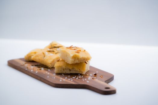 Italian focaccia with onion over a cutting board