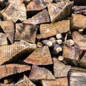 Lumber of various sizes stacked as a spare for the winter.