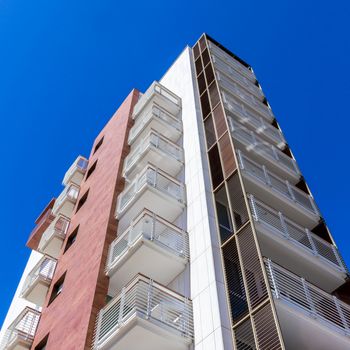 Modern condominium with blue sky background