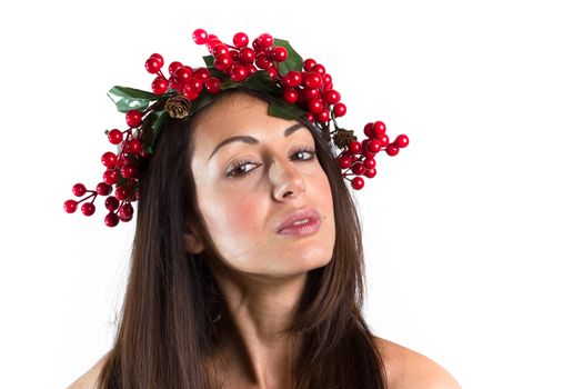 Christmas or New Year beauty woman portrait isolated on white background. Smiling young woman with wearing a Christmas wreath on her head. Natural makeup.