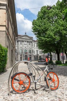 Mobike bicycle meant for bike sharing, parked in public area. Mobike a popular bike sharing platform where users grab bikes through an app in many places in Italy and in the world. Bergamo, ITALY - May 11, 2018.