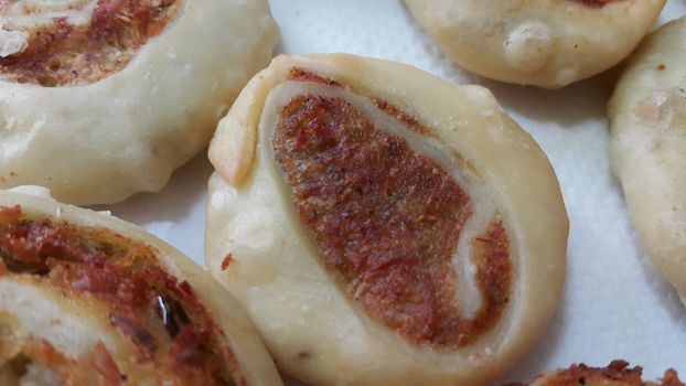 Closeup of delicious home made pinwheel puff pastries food item placed over white background