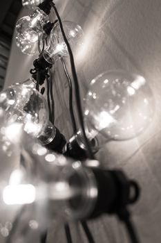 Decorative light bulbs against wall background. Bottom view. Candid shallow DOF.