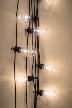 Decorative light bulbs against wall background