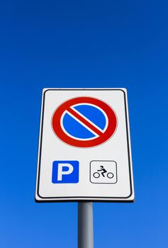 Do not park signage, motorcycle parking only. Background blue sky for copy space.