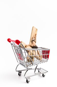 Crucifix in shopping cart. Conceptual representation of commodification of religion, loss of faith, blasphemy.