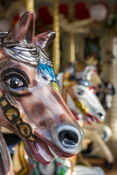 Extreme close-up of a toy horse on an old carousel.