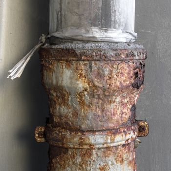 Closeup of an old rusty metal drainpipe