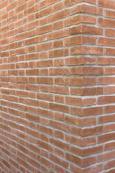 Front view of a wall with bricks arranged in a regular mode.