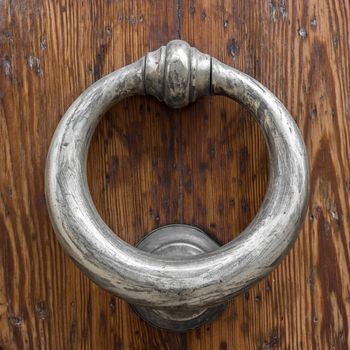 Decorative vintage door handle on a wooden door
