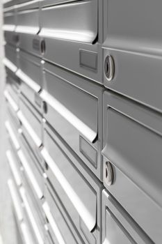 Rows of new aluminum mailboxes for concepts such as safety and security, business and communication.