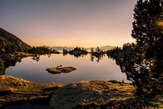Sunrise lake in the Spanish Pyrenees, located at mountain hut JM Blanc, Aigüestortes i Estany de Sant Maurici national park